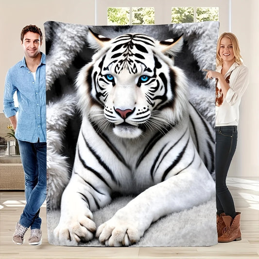 A large wall tapestry featuring a realistic print of a white tiger with blue eyes, held up by a man on the left and a woman on the right in a bright room.