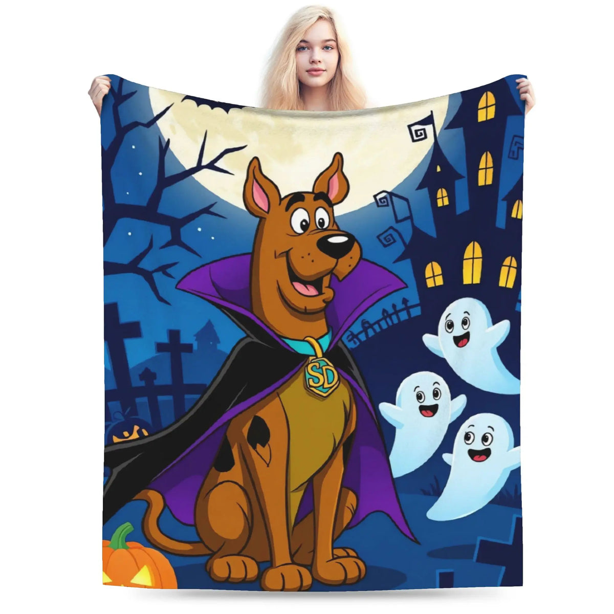 A fleece blanket featuring a cartoon Scooby-Doo vampire design, held up by a woman against a plain white background.