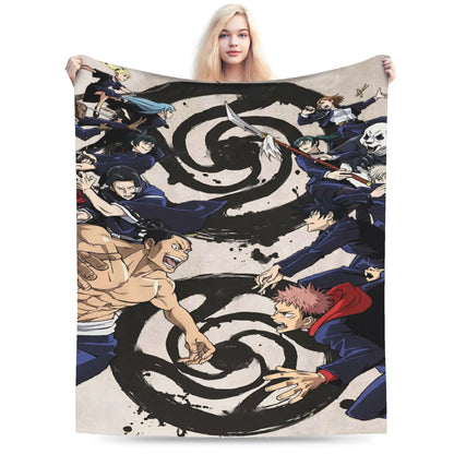 A person holding up a large printed blanket or tapestry featuring anime characters arranged around a bold black spiral motif on a light background.