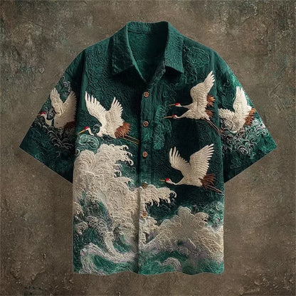 Green shirt with crane and wave design on a textured brown background