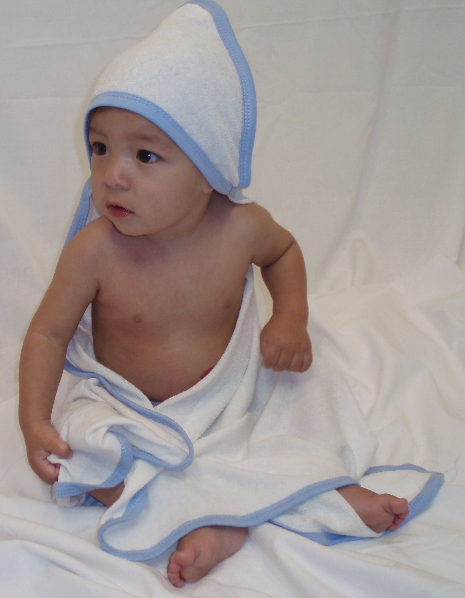 Emerald Clover infant hooded bath towels pack of 2 white cotton towels with blue trim on seated baby
