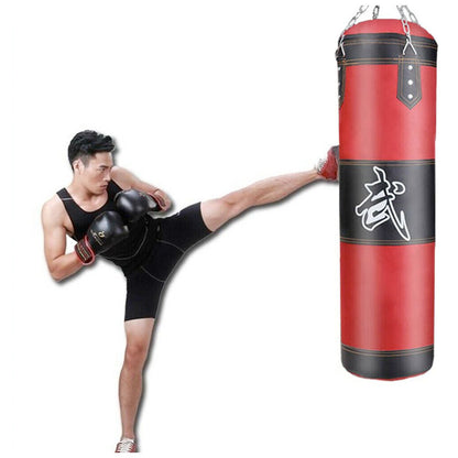 Man demonstrating a kick with a boxing punching bag set in a vibrant red color