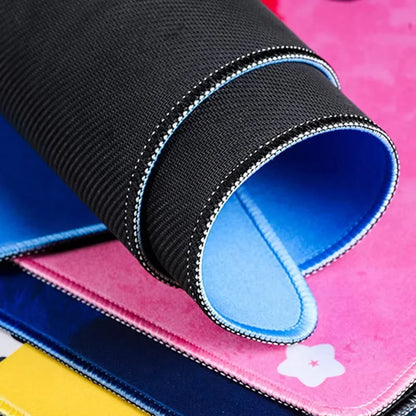 MRGLZY large gaming mouse pad rolled to show black textured surface and blue stitched underside