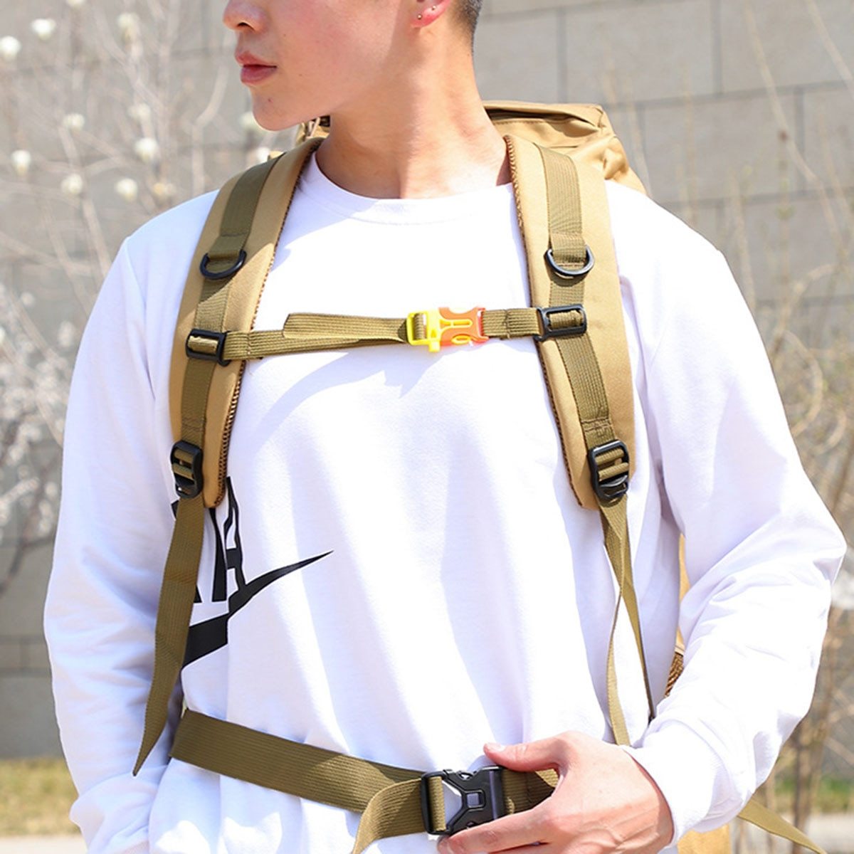 Yellow Pandora waterproof military backpack 70L shown on a person wearing a long-sleeve shirt outdoors